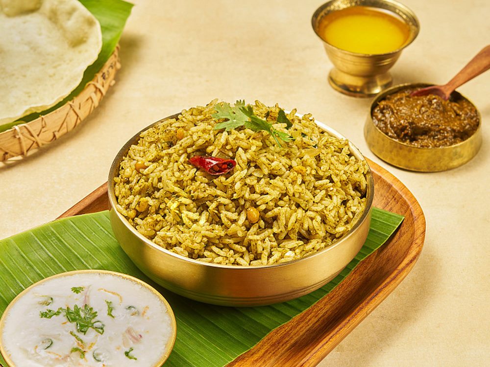 Gongura rice in a brass bowl on a banana leaf