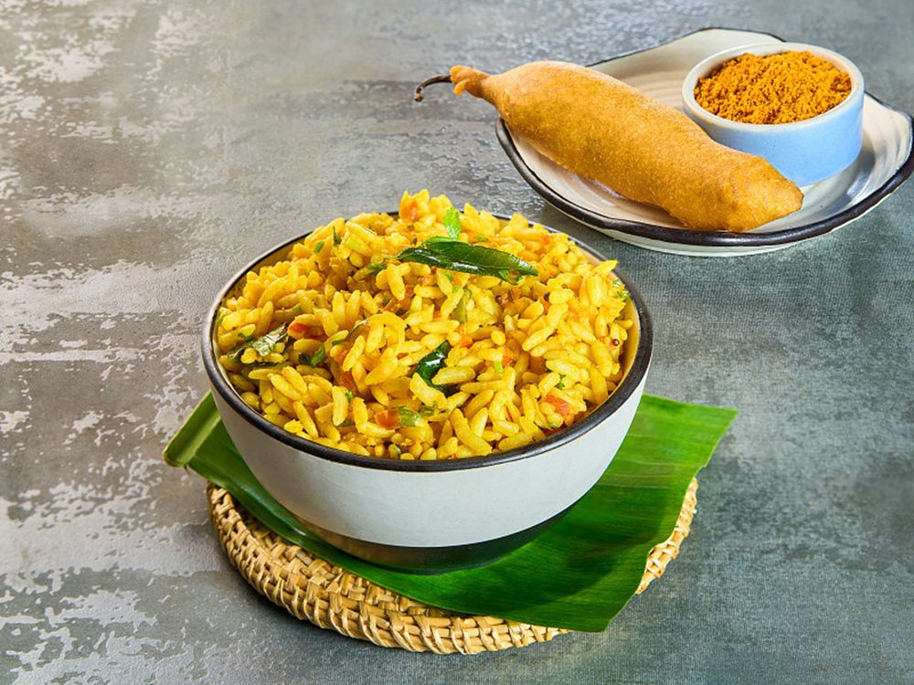 Uggani in a bowl with a mirchi bajji and podi behind