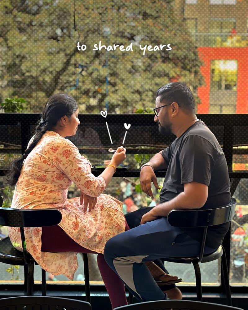 A couple sharing a plate at a window table