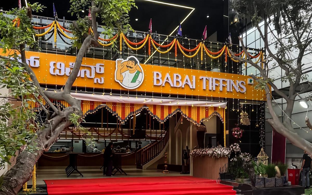 Babai Tiffins HSR Layout on opening day, the frontage hung with marigold garlands