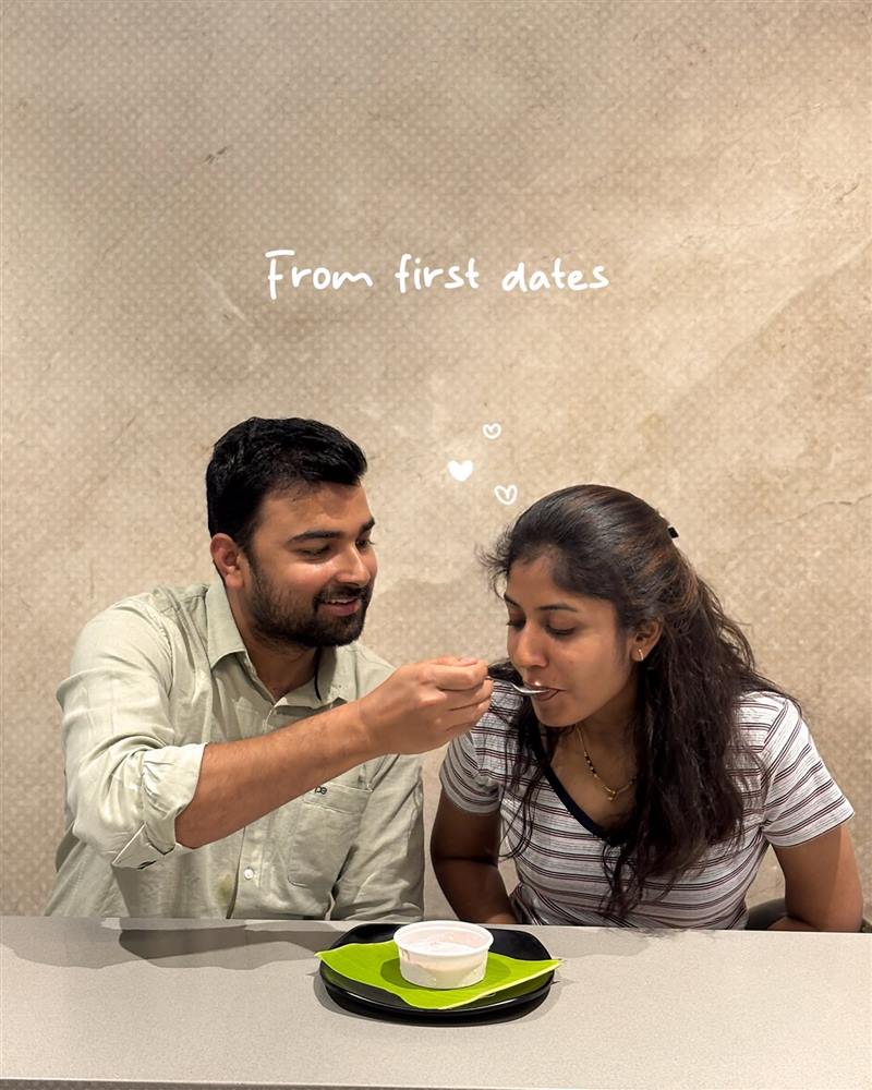 A couple at a Babai Tiffins table, one feeding the other a spoonful
